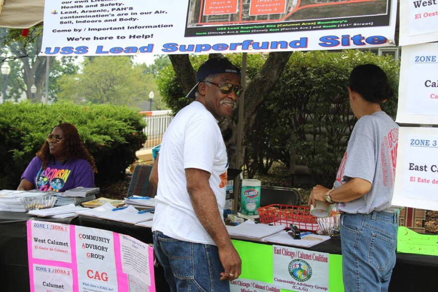 Ray Mosley works at the Community Advisory Group table with Akeeshea Daniels, left, and Maritza Lopez at Calumet Day, an annual block party. The CAG represents residents of the EPA-administered USS Lead Superfund site in East Chicago.