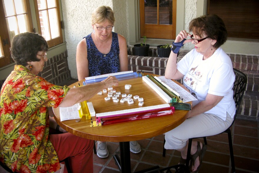 Cheri Babich (center) and her friends gather at the Broadmoor library for a weekly game of mahjong. Residents rallied to save the building after the low-lying area was designated to become a park in the aftermath of extensive Katrina-related flooding.