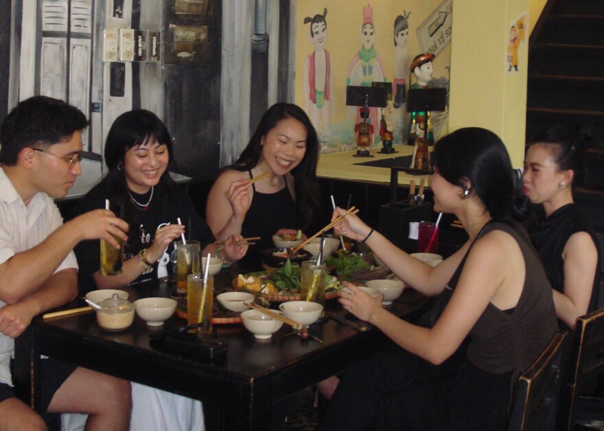 Minnie Phan, Senior Development Manager at KALW Public Media, sharing a meal at Bun Dau Homemade in Saigon with friends.
