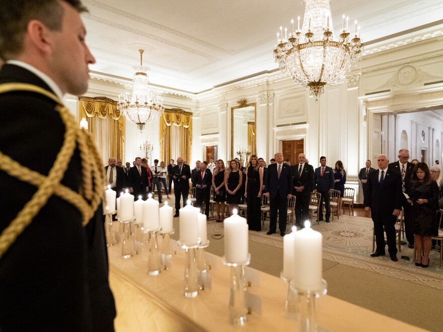 President Donald Trump and First Lady Melania Trump join guests in singing "America the Beautiful" during a reception in honor of Gold Star Families on Sept. 27, in the East Room of the White House.
