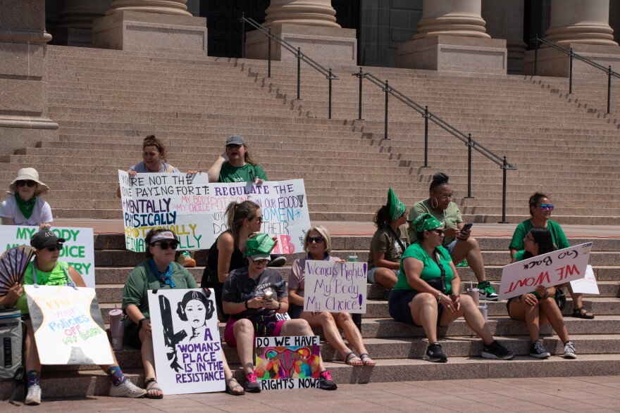Demonstrators sit on the steps of the Oklahoma Capitol during the 2024 OKC Women’s Strike.