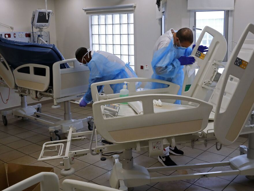 Medical staff from Tel Aviv Sourasky Medical Center clean and disinfect areas of the hospital dedicated to receiving patients suffering from COVID-19, on March 19.