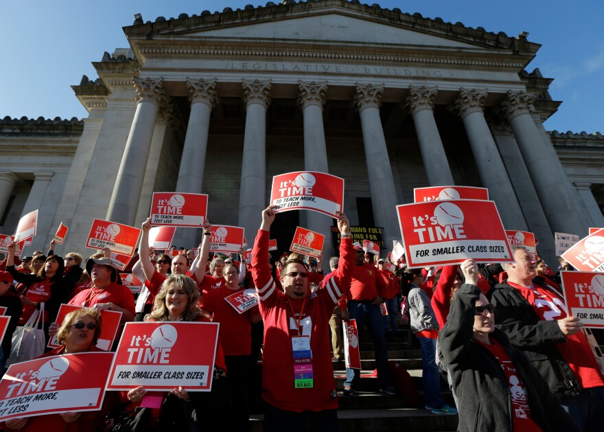 Hundreds of Washington state teachers and other supporters fill the steps of the Legislative Building as they cheer and hold signs Saturday, April 25, 2015 at a Washington Education Association rally at the Capitol in Olympia, Wash.