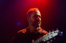 Charlie Hunter playing a guitar.