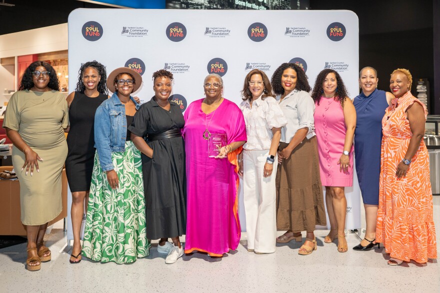Attendees and community leaders stand with Dr. Maggie Young, a member of the SOUL Fund’s steering committee who was presented with the Soul of Philanthropy Award.