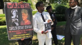John Barnett holds a flyer he is distributing, asking the Raleigh community to help him find Carolyn Bryant Donham. Barnett and Rev. Nathaniel Cox, right, say Donham needs to pay for her role in the lynching of Black teenager Emmett Till, back in 1955. Photo taken July 28, 2022