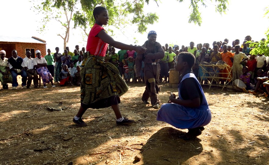 In a play written and staged by young people in Sandrack, Malawi, a mother and father tell their daughter she must drop out of school and get married. An older man has promised them a big dowry for their daughter's hand.