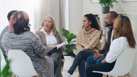 Counseling, group and psychology discussion with group of diversity people in therapy for depression, stress and anxiety. Men and women healing during psychologist meeting talking about mental health.