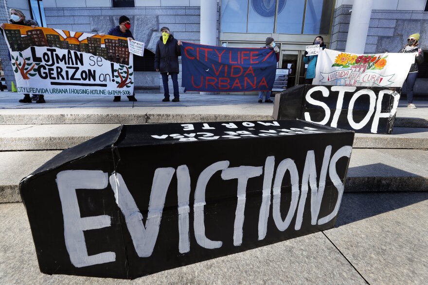 In this Jan. 13, 2021, file photo, tenants' rights advocates demonstrate in front of the Edward W. Brooke Courthouse in Boston. 