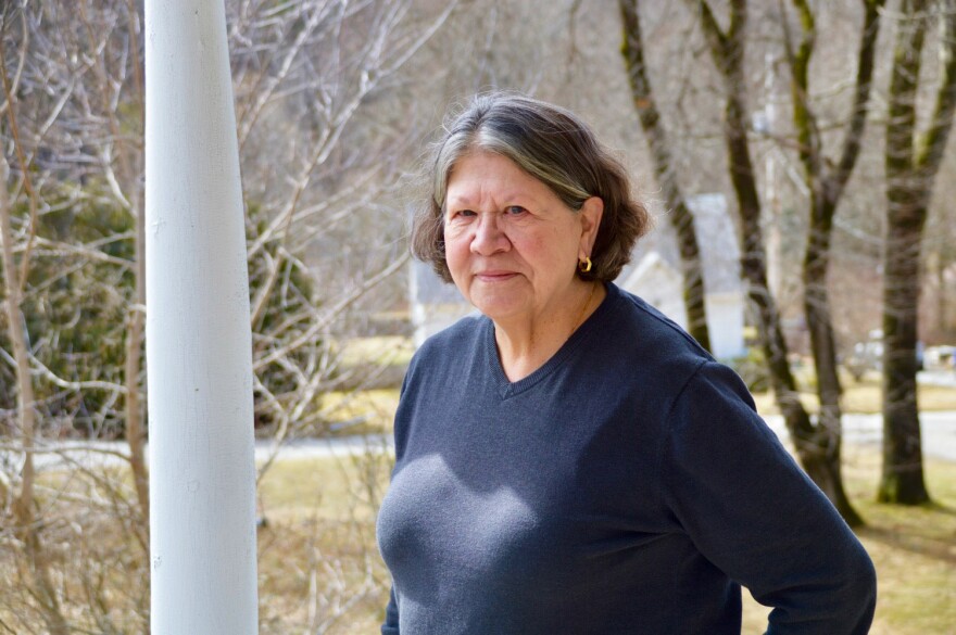 A person stands on a porch.