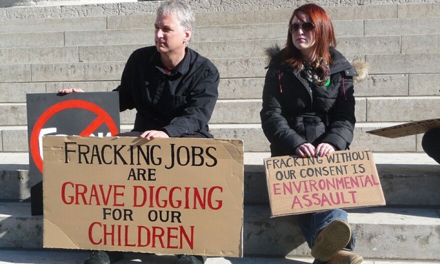 people holding anti-fracking signs