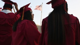 A U.S. flag flies above a building as students earning degrees at Pasadena City College participate in the graduation ceremony, June 14, 2019, in Pasadena, California. (Robyn Beck/AFP/Getty Images)