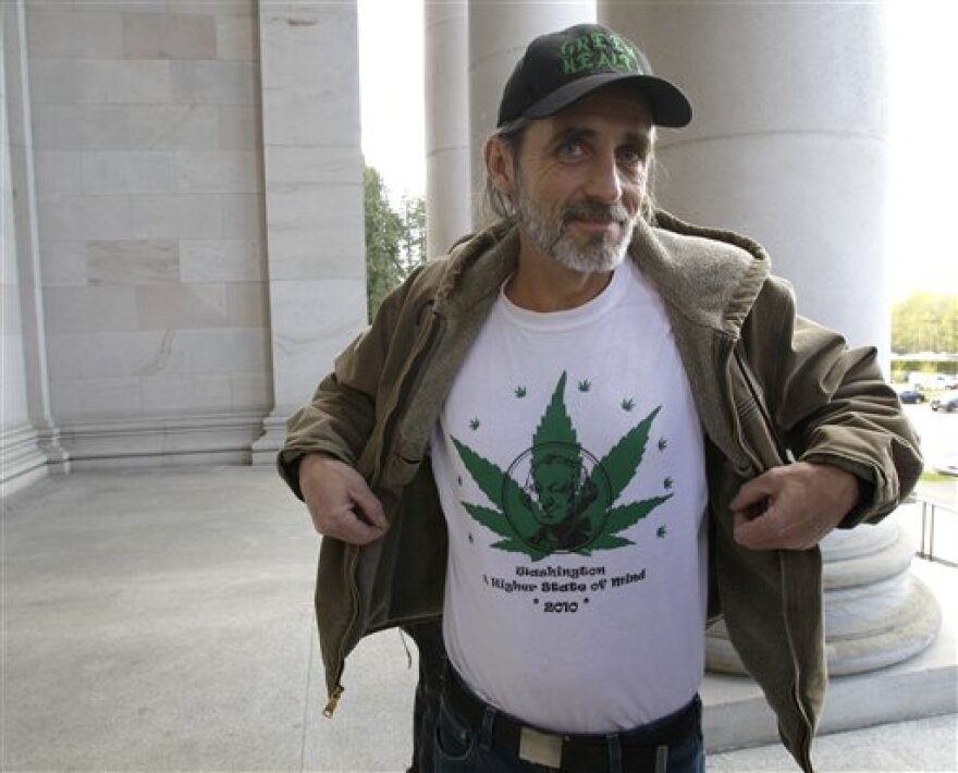 Brian Pfister, owner of Green Health, which operates four medical marijuana dispensaries in western Washington, displays a shirt that reads "Washington, a higher state of mind," last month, outside the Capitol in Olympia.