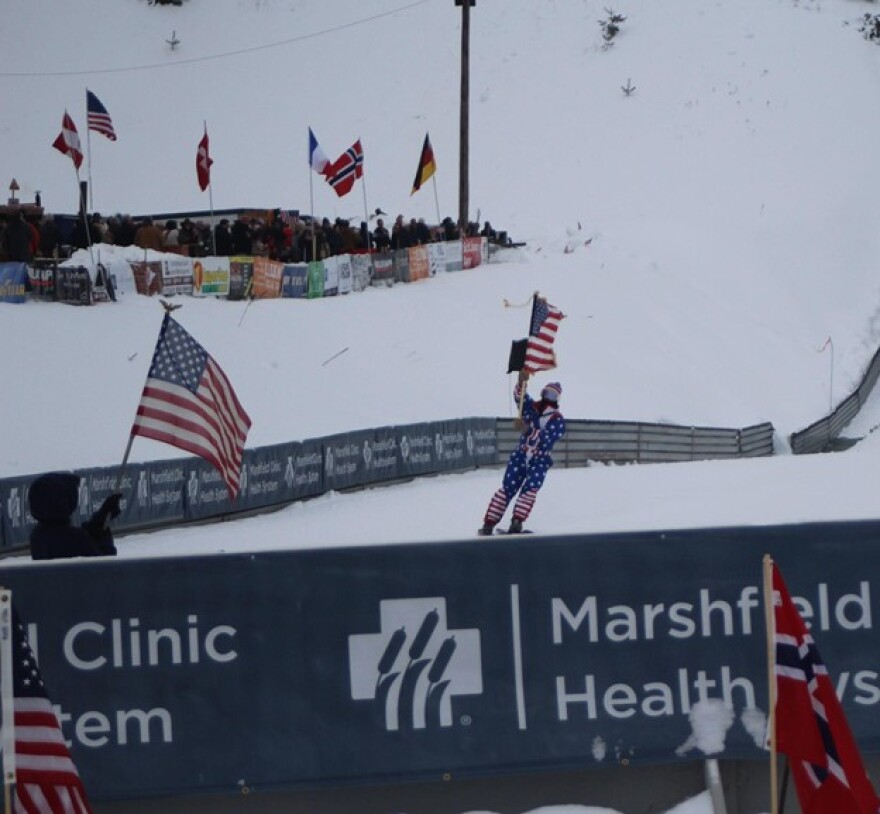 Iron Mountain Native Levi Verrette skied half way down the mountain with the American flag during the Opening Ceremonies of the Pine Mountain Continental Cup Saturday February 21.