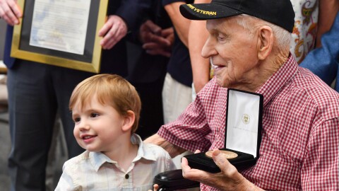 Sgt. Joseph Drake was honored in a ceremony at the Wayne County Courthouse for receiving the Congressional Gold Medal. He is one of only five surviving World War II Army Rangers. He holds his great-grandson, Everett Rotella, 3.