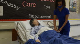 Andrea Zaknoun, a CTE student at A.K. Smith Career Center studying to become a certified nursing assistant, practices on a mannequin in a classroom during a Summer Bridge program. (Justin Hicks/IPB News)
