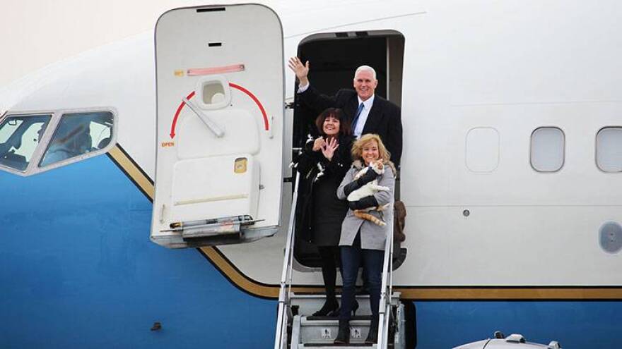 Vice President-elect Mike Pence boards the plane with his wife Karen, his daughter Charlotte and family cats Oreo and Pickle.