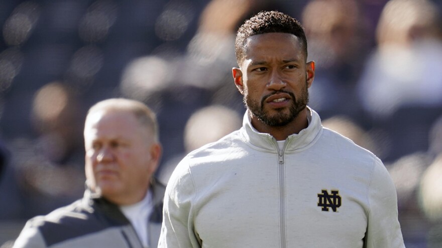 Notre Dame defensive coordinator Marcus Freeman watches during warmups before an NCAA college football game against Navy in South Bend, Ind., Saturday, Nov. 6, 2021.