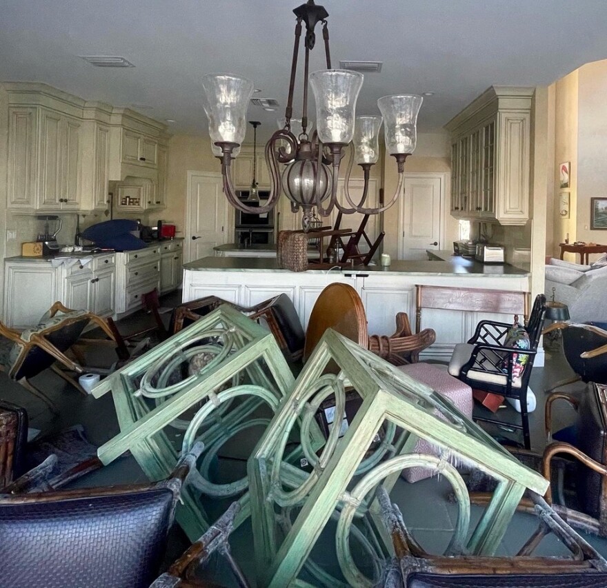 Piles of furniture inside of a home.