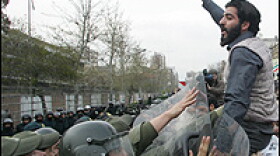 Iranian riot police prevent hardline students from approaching the British embassy in Tehran during a protest Sunday. The students are demanding the trial of 15 British sailors and marines.