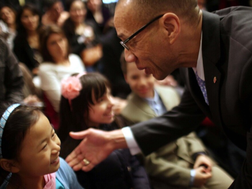 Deputy mayor for education Dennis Walcott speaks with school children after being introduced by New York Mayor Michael Bloomberg as New York City's new Schools Chancellor following the departure of the controversial Cathleen Black on April 7 in New York City.