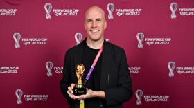 Grant Wahl with a World Cup replica trophy, in recognition of his achievement covering 8 or more FIFA World Cups, during a ceremony at the Main Media Centre on Nov. 29 in Doha, Qatar.
