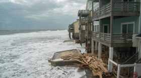 Debris washes up onto an old swimming pool as a storm approaches.