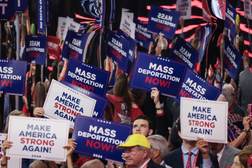 MILWAUKEE, WISCONSIN - JULY 17: People hold signs that read "Mass Deportation Now" and "Make America Strong Again" on the third day of the Republican National Convention at the Fiserv Forum on July 17, 2024 in Milwaukee, Wisconsin. Delegates, politicians, and the Republican faithful are in Milwaukee for the annual convention, concluding with former President Donald Trump accepting his party's presidential nomination. The RNC takes place from July 15-18. (Photo by Scott Olson/Getty Images)