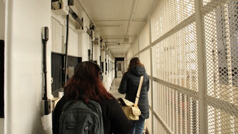 A walkway at the State Correctional Institution at Rockview has narrow space for people between inmate cells and a metal wall of bars and grates.