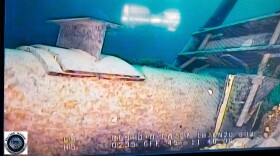 FILE - This photo provided by the Michigan Department of Environment, Great Lakes, and Energy in June 2020 shows damage to anchor support EP-17-1 on the east leg of the Enbridge Line 5 pipeline in the Straits of Mackinac in Michigan, displayed on a television screen.