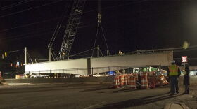 Workers lift a girder into place for the Lynx Blue Line Extension over Harris Boulevard in February 2016. 
