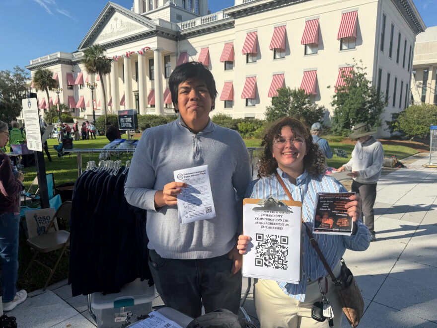 Alonzo Garcia, left, and Sarah Milan attend the No Kings rally on Oct. 17, 2026, in Tallahassee. They’re collecting petition signatures to undo Tallahassee’s agreement to cooperate in immigration enforcement.