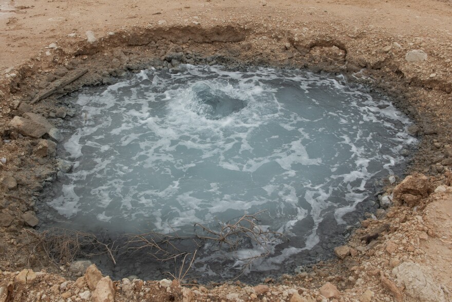 The Sloan Blair No.1, which is the well that feeds Lake Boehmer, releases hundreds of gallons per minute. The impurities in the water change the stones around it to a bluish gray color.