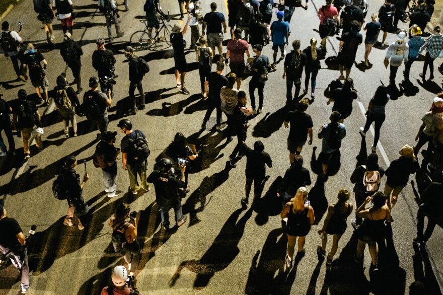 Demonstrators march in the streets on August 26, 2020 in Kenosha, Wisconsin. As the city declared a state of emergency curfew, a fourth night of civil unrest occurred after the shooting of Jacob Blake, 29, on August 23.