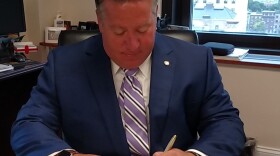 Albany County Executive Dan McCoy signs the executive order.