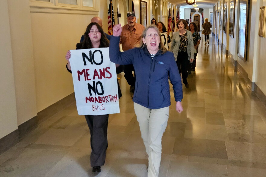 Demonstrators ordered out of the Missouri House public gallery during a debate on anti-abortion legislation march and chant Wednesday, May 13, 2026, in the Missouri Capitol Building.