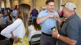 Democratic senate candidate Lucas Kunce, center, talks to an attendee of the Missouri State Fair’s Ham Breakfast on Thursday, Aug. 17, 2023, in Sedalia, Mo. 