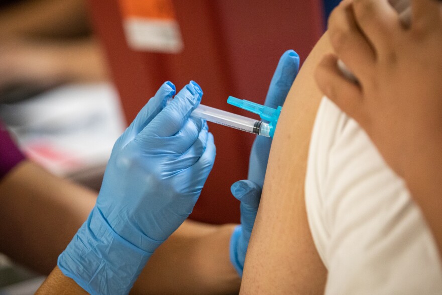 A COVID-19 vaccine is administered to a patient in East Austin.