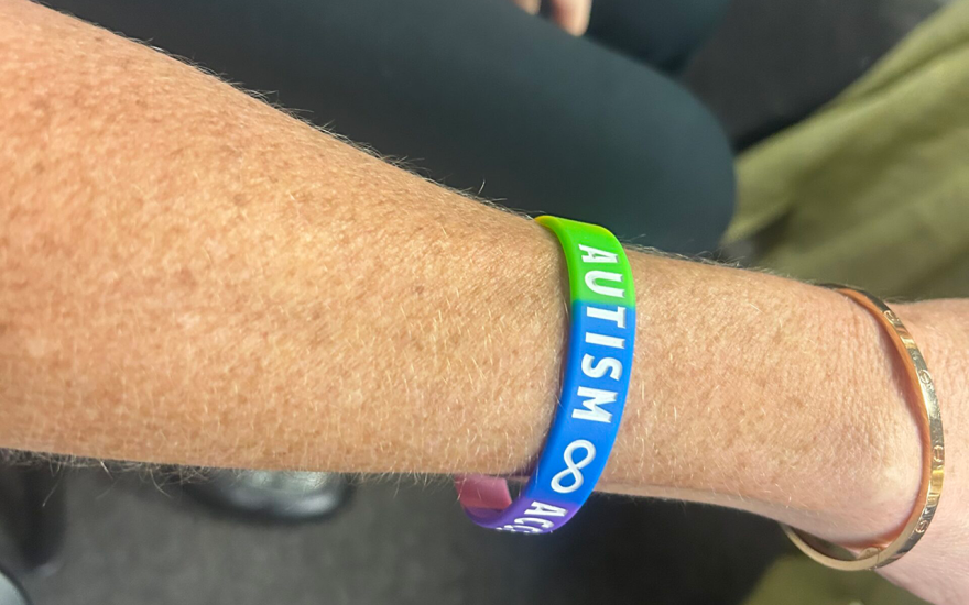 Autism awareness bracelet worn by an audience member at the Aug. 31, 2026, ABA Task Force meeting in Tallahassee.