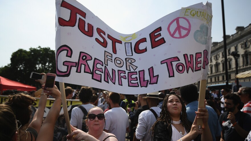 Protesters in London on Wednesday call for justice for the victims of the Grenfell Tower blaze. They joined other demonstrators in what they called a "day of rage" to protest perceived government inaction and neglect.