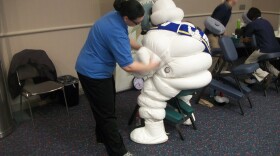 Michelin Man takes a break at the Detroit Auto Show for a chair massage.