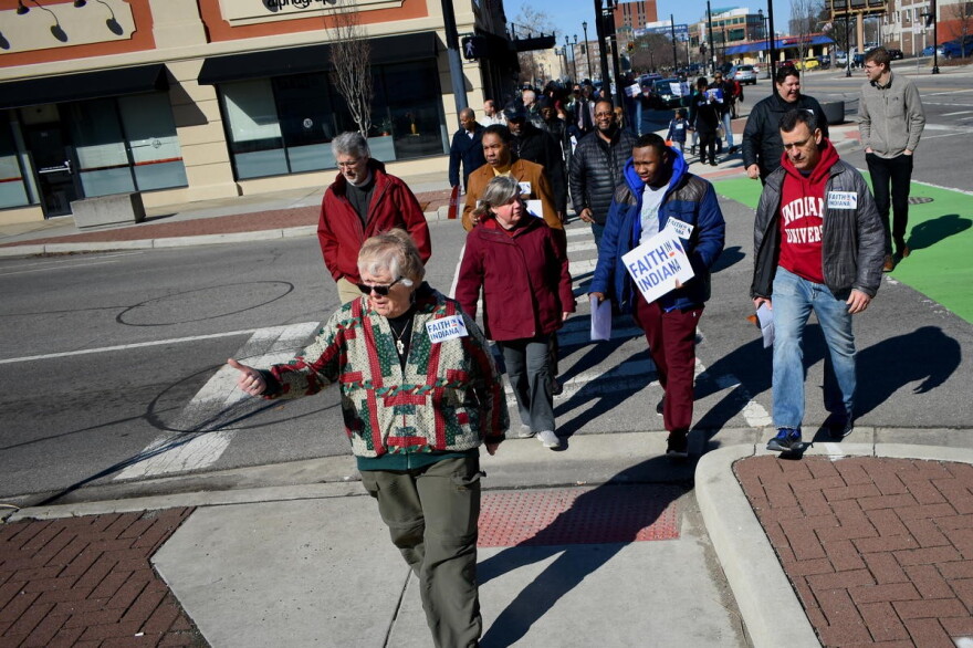 A group organized by Faith In Indiana marched to the site of Eric Logan's shooting and then the mayor's office building on Saturday.