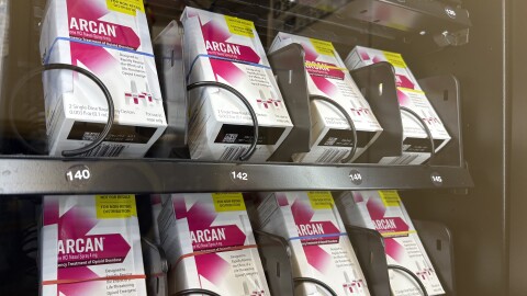 Eight white boxes sit inside a vending machine.