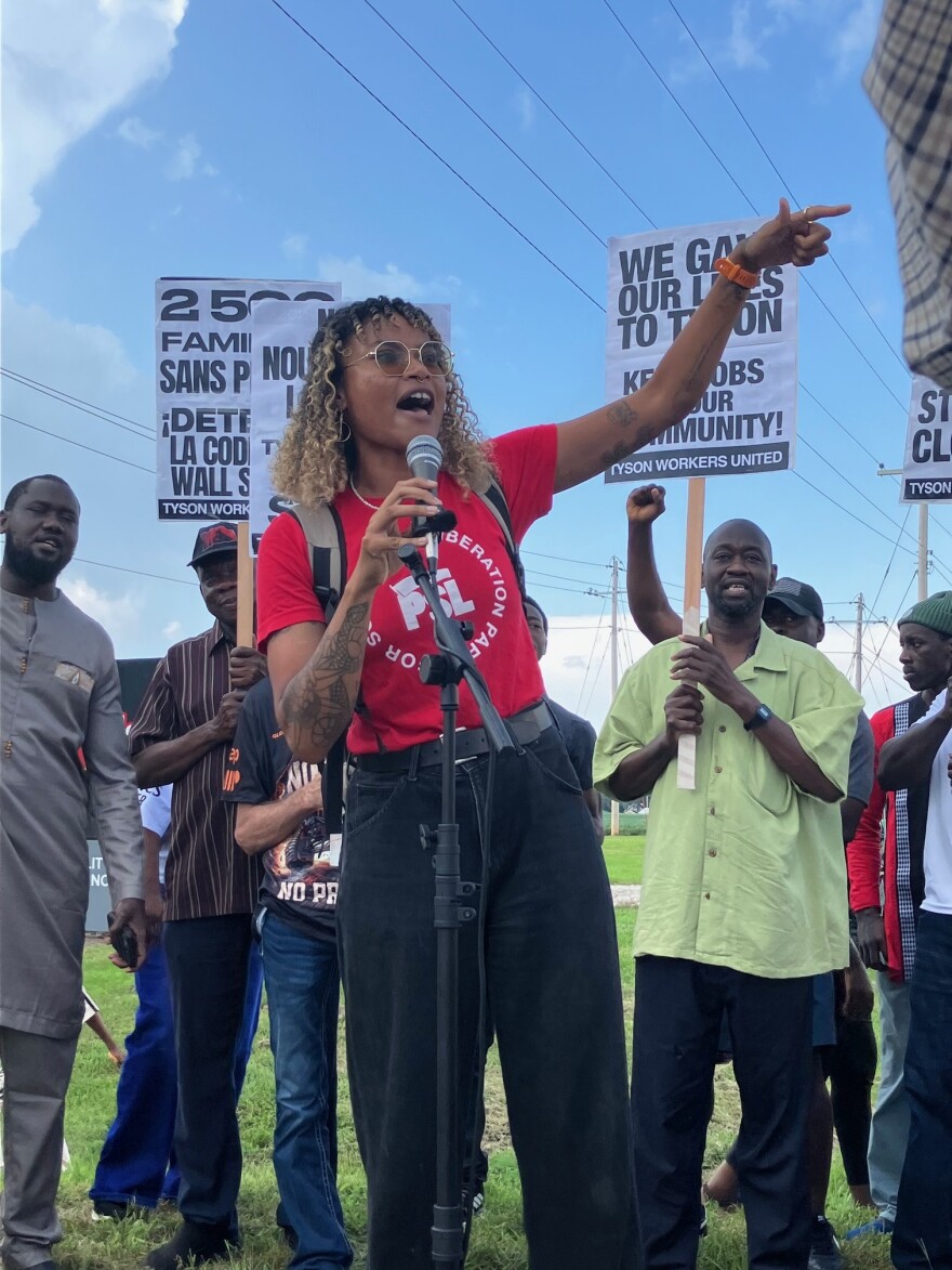 Deja Gaston, organizer for the Party for Socialism and Liberation, lead chants at the Tyson worker rally outside the plant in Joslin, Ill., Friday, Aug. 21, 2026.