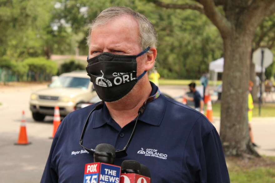 Orlando Mayor Buddy Dyer talks with reporters at a testing site at the Northwest Community Center. 