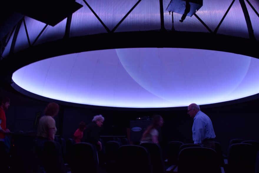 The UMSL planetarium's domed screen is illuminated prior to a show.