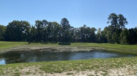A pond next to a new warehouse in Suffolk on the Former Nansemond Ordnance Depot Superfund site, where thousands of military munitions have been found. (Photo by Katherine Hafner)