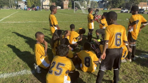 Constance Lane Elementary School's Fourth Grade soccer team huddles up on the side of the field during their game