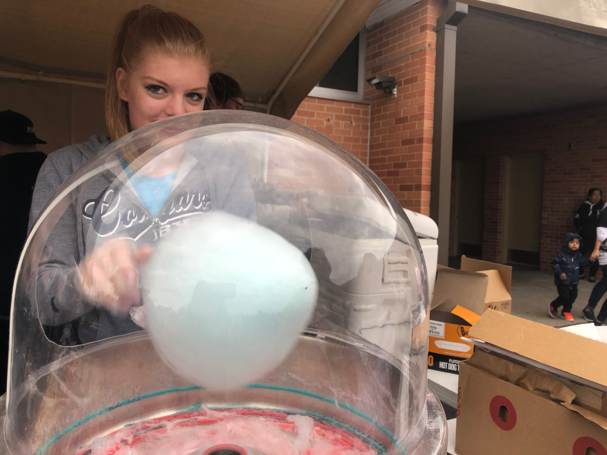 A volunteer spins cotton candy at the Rosehill Elementary School carnival