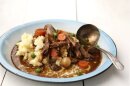 Stout-braised short ribs with creamy mashed potatoes. (Photo by Carmen Troesser, courtesy Sauce Magazine.)